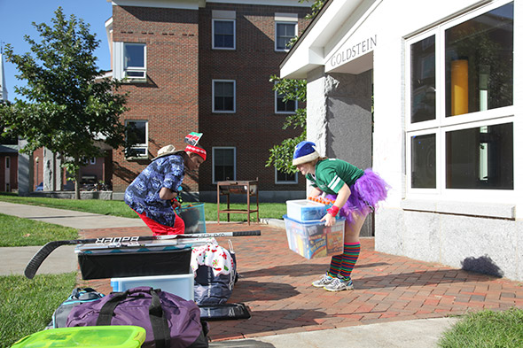 Two Undergraduate Advisors help first-year students move into Goldstein Hall, which is part of the McLaughlin Cluster. The new Global Village community is based in the Cluster. (Photo by Corinne Arndt Girouard) 